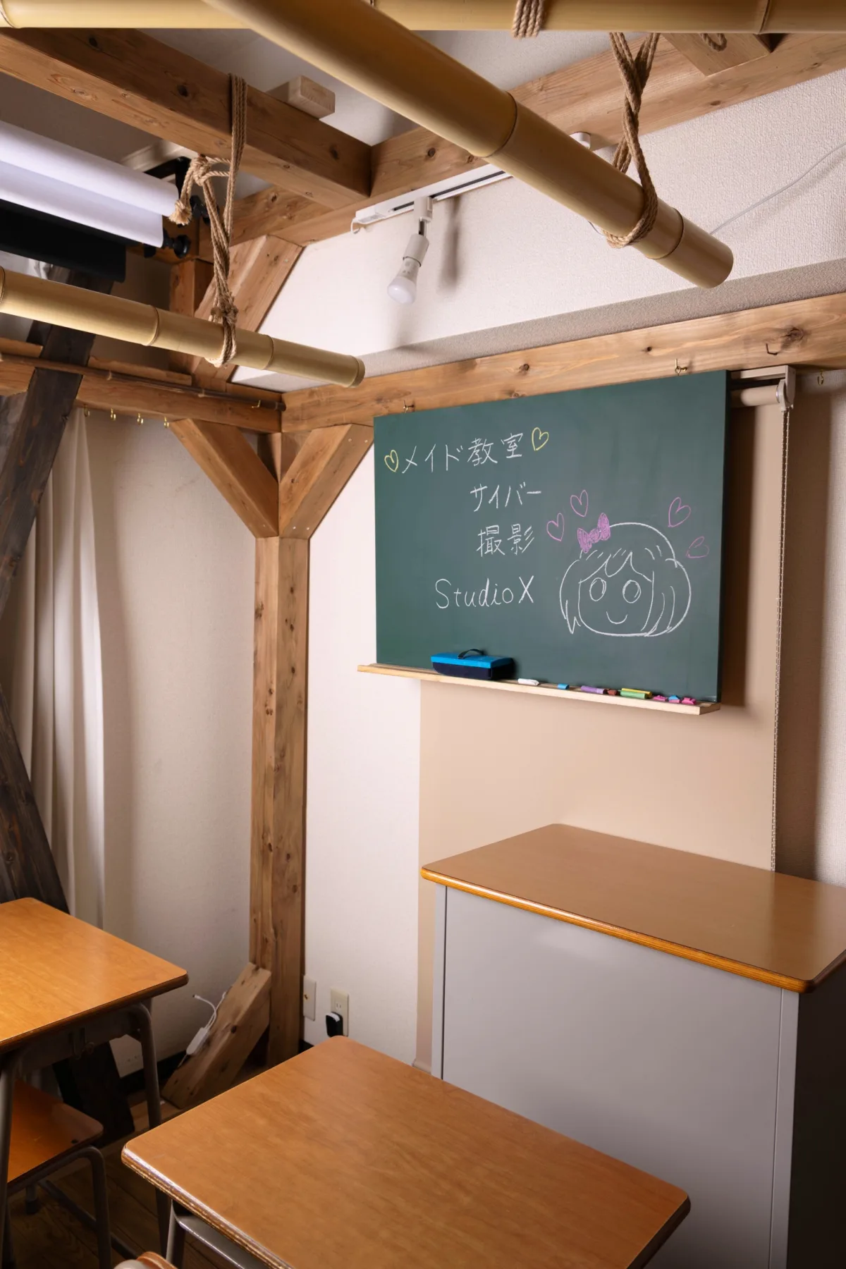 学校机、黒板、木組みフレームのあるスタジオ内観